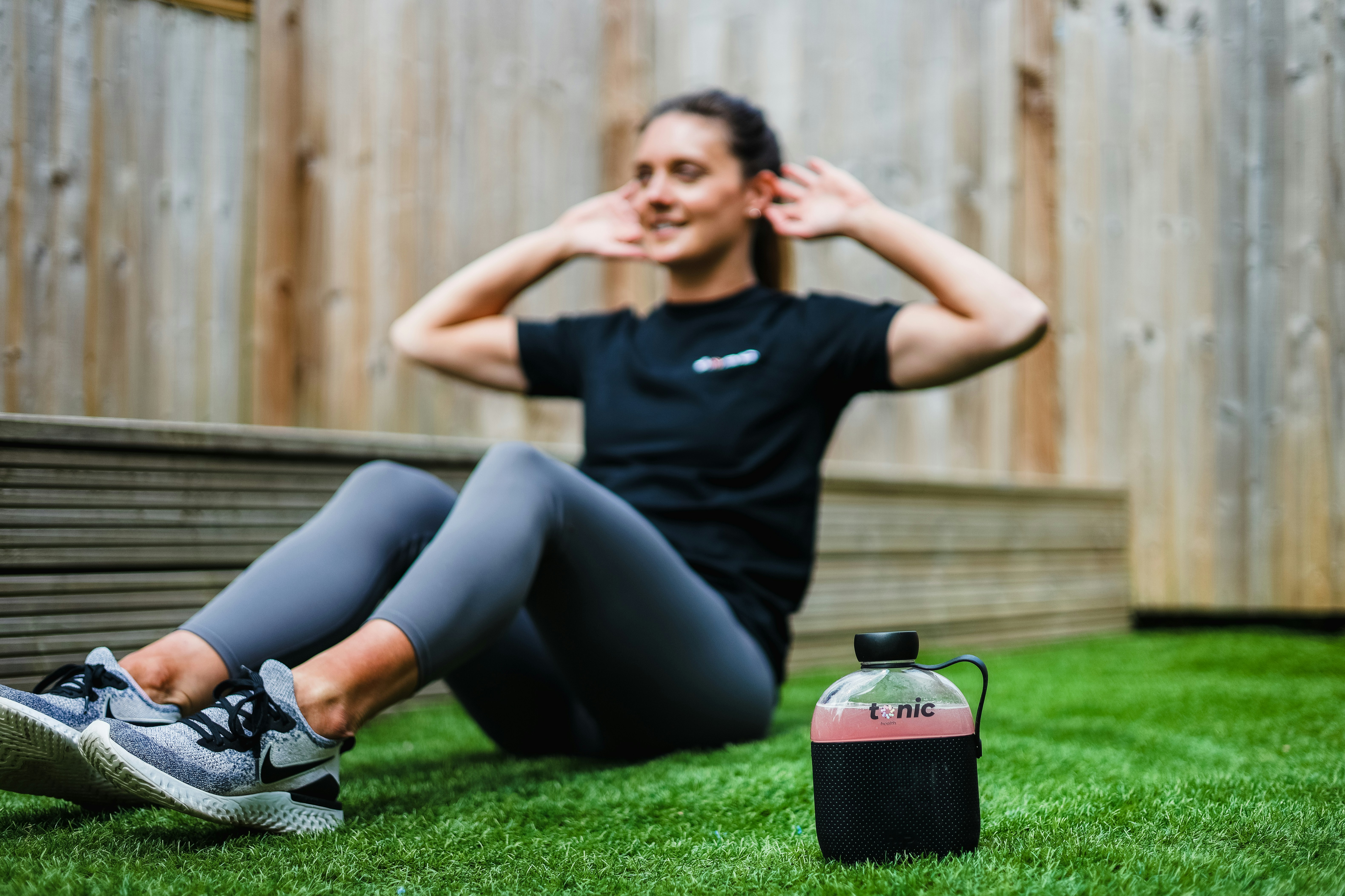 young woman exercising in the grass